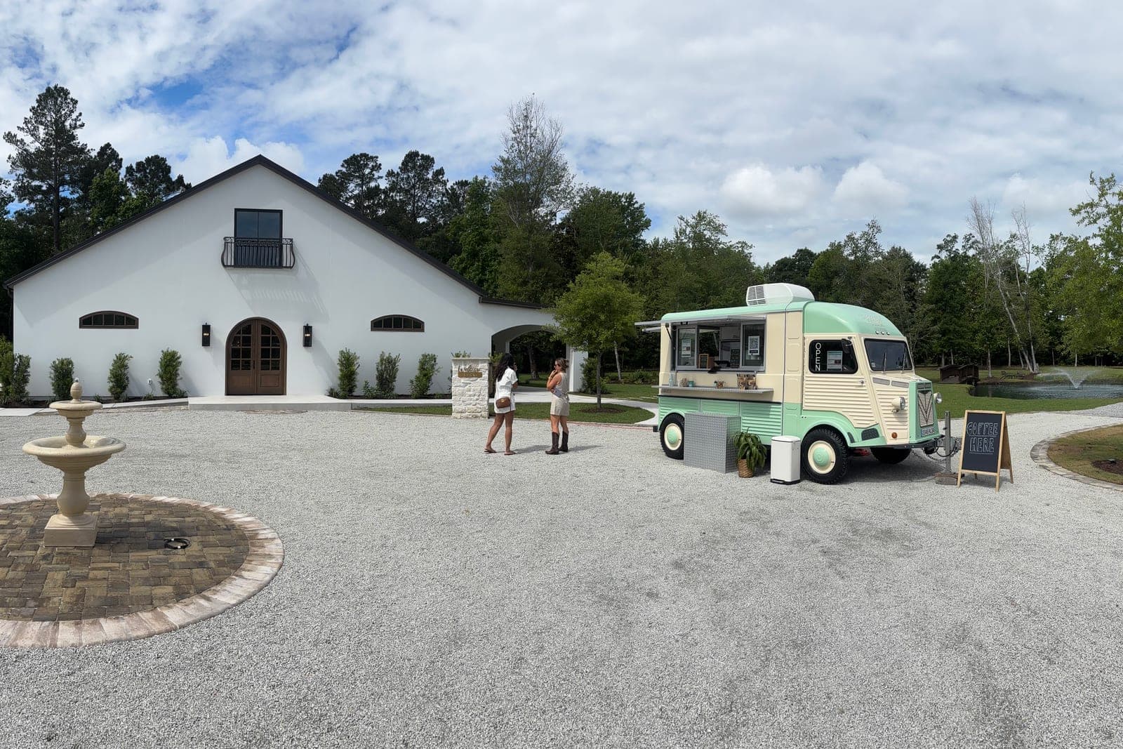 Guests ordering espresso from the Common Tides wedding coffee catering trailer at Oak and Fennel wedding venue near Wilmington NC
